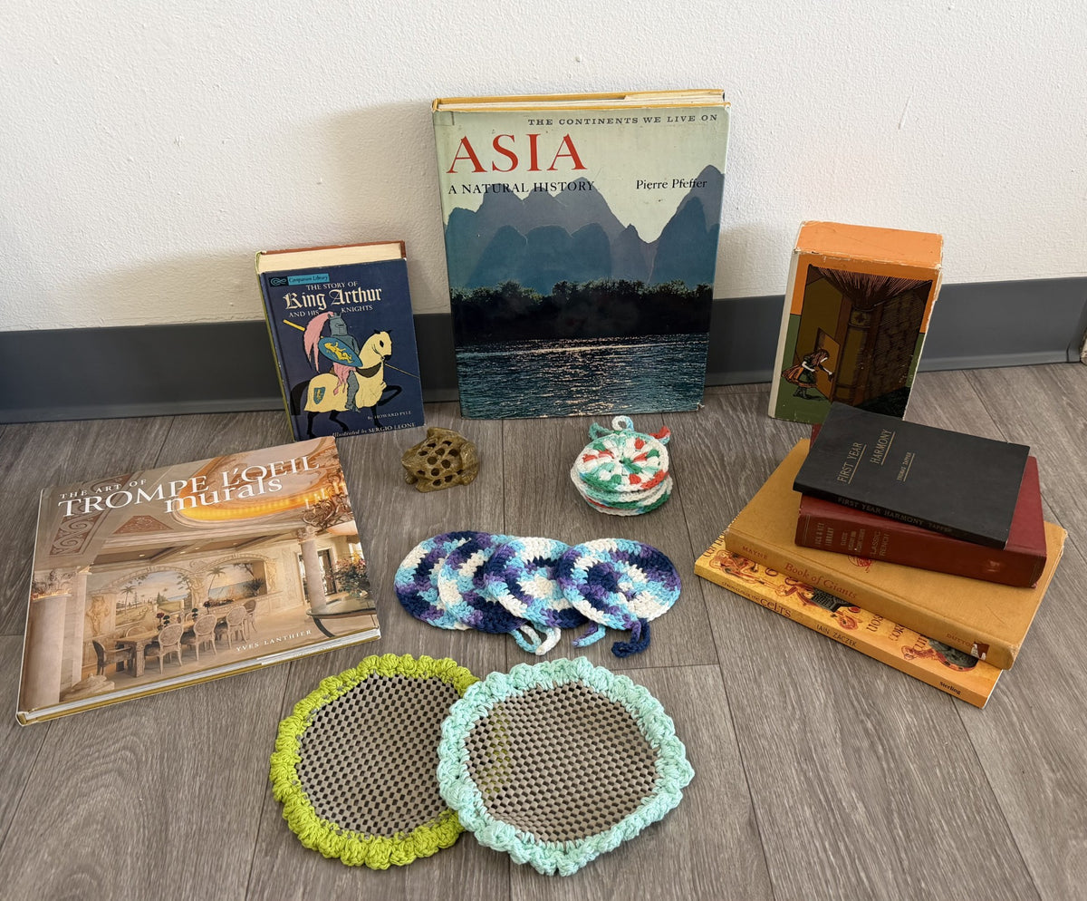 A collection of vintage books and handmade crochet pieces — a glimpse into the treasures you'll find at Just Bee Mee