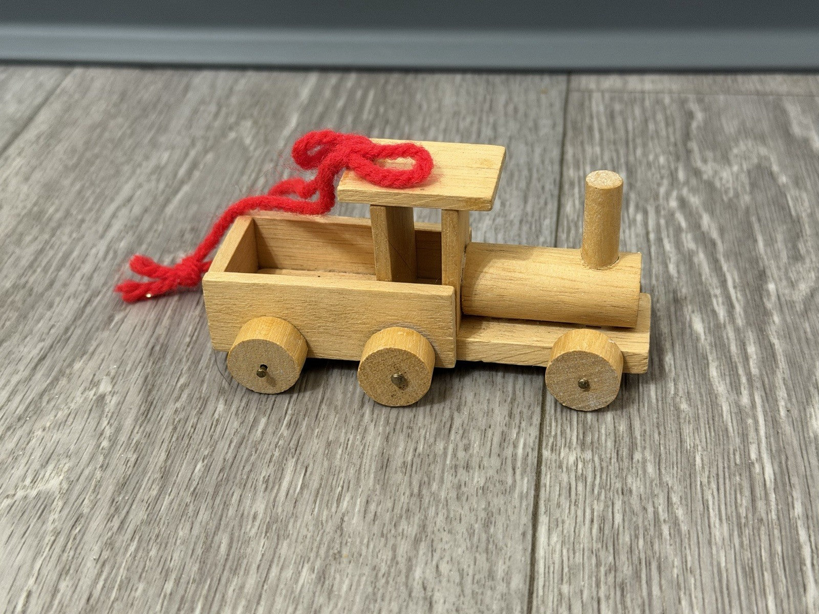 Vint. Wooden Christmas Ornament Unpainted Train Engine W/ Red Yarn Hanging Loop