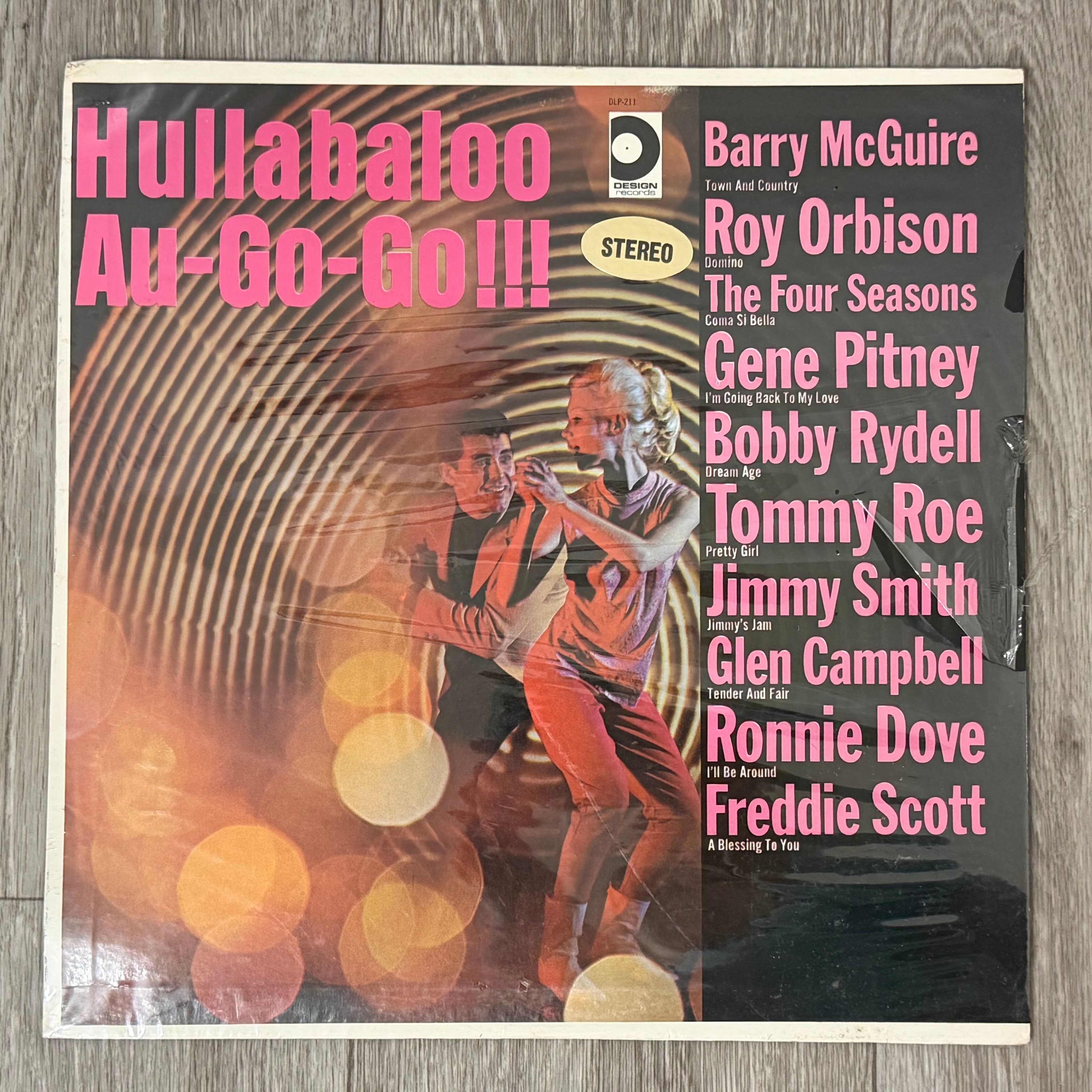Vinyl record cover with a dancer and text on a wooden surface